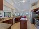 Well-appointed kitchen flows into a dining area and offers views of the outdoor living space at 5035 Collingswood Blvd, Port Charlotte, FL 33948