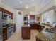 Modern kitchen features granite countertops, stainless steel appliances, and a convenient center island at 5035 Collingswood Blvd, Port Charlotte, FL 33948
