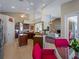 Open concept kitchen with island, stainless steel appliances and views to dining and living area at 5035 Collingswood Blvd, Port Charlotte, FL 33948