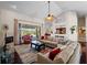Inviting living room featuring a fireplace, sliding doors to the patio, and open access to the kitchen at 5035 Collingswood Blvd, Port Charlotte, FL 33948