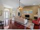 Bright living room features high ceilings, fan, fireplace, and access to multiple rooms at 5035 Collingswood Blvd, Port Charlotte, FL 33948