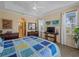Large main bedroom with en-suite bathroom, large window, and ceiling fan at 5035 Collingswood Blvd, Port Charlotte, FL 33948