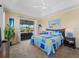 Spacious main bedroom with coastal decor, ceiling fan, and sliding glass doors to the outdoor space at 5035 Collingswood Blvd, Port Charlotte, FL 33948
