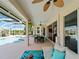 Covered patio with a dining area and seating space, leading to an outdoor pool area, and sliding doors to the interior at 5035 Collingswood Blvd, Port Charlotte, FL 33948