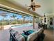 Spacious covered patio with both seating and dining areas, plus a view of the pool and a scenic backdrop at 5035 Collingswood Blvd, Port Charlotte, FL 33948