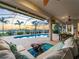 Comfortable outdoor seating area on a screened patio overlooking a pool and waterfront scenery at 5035 Collingswood Blvd, Port Charlotte, FL 33948
