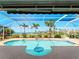 Sparkling swimming pool with a built-in table, surrounded by lush landscaping and views of the waterfront at 5035 Collingswood Blvd, Port Charlotte, FL 33948