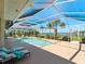 Enclosed pool area with clear views of the water and surrounding landscaping at 5035 Collingswood Blvd, Port Charlotte, FL 33948