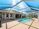 An inviting screened-in pool with ample seating area, perfect for entertaining and relaxation at 5035 Collingswood Blvd, Port Charlotte, FL 33948