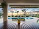 Inviting screened-in pool area with a beautiful view and tropical landscaping, perfect for outdoor living at 5035 Collingswood Blvd, Port Charlotte, FL 33948