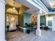 Inviting front porch with decorative plants and seating offering a warm welcome at 5035 Collingswood Blvd, Port Charlotte, FL 33948
