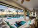 Spacious screened-in patio featuring comfortable seating, dining area, and a sparkling pool with a scenic view at 5035 Collingswood Blvd, Port Charlotte, FL 33948