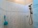 Updated shower with rainfall shower head and blue tiled walls at 5035 Collingswood Blvd, Port Charlotte, FL 33948