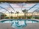 Beautiful screened-in pool with a lovely view and a relaxing fountain feature at 5035 Collingswood Blvd, Port Charlotte, FL 33948