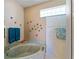 Bright tub area with a soaking tub and stylish starfish decorations at 5035 Collingswood Blvd, Port Charlotte, FL 33948
