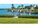 Scenic waterfront featuring a private dock, lush greenery, and serene blue waters at 5035 Collingswood Blvd, Port Charlotte, FL 33948