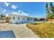 Beautiful single-story home with manicured lawn, gravel driveway, and inviting covered patio area at 507 Buena Vista Dr, Nokomis, FL 34275