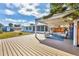 Expansive backyard featuring a spacious wooden deck and a covered patio perfect for outdoor enjoyment at 507 Buena Vista Dr, Nokomis, FL 34275