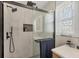 Modern bathroom features a glass shower with a rainfall shower head and neutral tile surround at 507 Buena Vista Dr, Nokomis, FL 34275