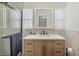 Modern bathroom with wood vanity, undermount sink and lighted mirror at 507 Buena Vista Dr, Nokomis, FL 34275