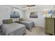 Bright bedroom features two beds with matching gray comforters at 507 Buena Vista Dr, Nokomis, FL 34275