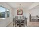 Cozy dining room featuring shiplap accent wall, stylish light fixture and table with seating for four at 507 Buena Vista Dr, Nokomis, FL 34275