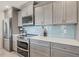 Well-equipped kitchen with stainless steel appliances and gray cabinetry at 507 Buena Vista Dr, Nokomis, FL 34275