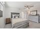 Calm main bedroom features soothing gray tones, a ceiling fan and wood-look planking at 507 Buena Vista Dr, Nokomis, FL 34275
