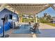 Inviting covered patio with cozy seating, a television, a ceiling fan, and views of the waterfront at 507 Buena Vista Dr, Nokomis, FL 34275