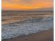 Scenic ocean view capturing a vibrant beach sunset with waves gently rolling onto the shore at 510 Airport E Ave # 2C, Venice, FL 34285