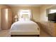 Serene bedroom featuring a queen-size bed, light wood furniture, and soft, natural light creating a relaxing atmosphere at 510 Airport E Ave # 2C, Venice, FL 34285