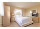 Inviting bedroom with a queen bed, soft white linens, and neutral tones providing a peaceful and airy ambiance at 510 Airport E Ave # 2C, Venice, FL 34285