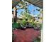 Cozy patio with brick pavers, Adirondack chairs, and a serene view of the surrounding greenery at 510 Airport E Ave # 2C, Venice, FL 34285