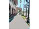 Charming Venice, Florida street view shows a pleasant sidewalk, shops, and beautiful architecture at 510 Airport E Ave # 2C, Venice, FL 34285