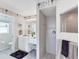 Bright bathroom features dual sinks, vanity, walk-in shower, and floral wallpaper at 5189 Pine Shadow Ln, North Port, FL 34287
