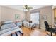 Comfortable bedroom featuring wood floors and well-lit interior at 5189 Pine Shadow Ln, North Port, FL 34287