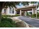 Covered entrance with manicured landscaping providing a welcoming feel at 5189 Pine Shadow Ln, North Port, FL 34287