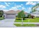Charming single-story home with lush landscaping, tile roof, and a two-car garage at 5189 Pine Shadow Ln, North Port, FL 34287
