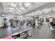 Bright gym featuring high ceilings, plenty of machines, and a view of the pool at 5189 Pine Shadow Ln, North Port, FL 34287