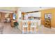 Open kitchen and breakfast bar with white cabinetry, stainless appliances, and pendant lighting at 5189 Pine Shadow Ln, North Port, FL 34287