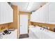 Functional laundry room offers abundant cabinetry, sink, and modern washer and dryer at 5189 Pine Shadow Ln, North Port, FL 34287