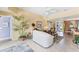 Bright living room with neutral tones, tile flooring, and a ceiling fan at 5189 Pine Shadow Ln, North Port, FL 34287