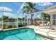 Screened-in pool and patio with lake views offer the perfect outdoor oasis at 5189 Pine Shadow Ln, North Port, FL 34287