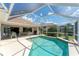 This screened-in pool features access to the home and nearby seating at 5189 Pine Shadow Ln, North Port, FL 34287