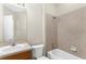 Bright bathroom with tiled shower, vanity with sink, and white toilet at 5255 Layton Dr, Venice, FL 34293
