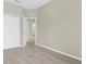 A bedroom features neutral walls, carpet, and a white closet door at 5255 Layton Dr, Venice, FL 34293