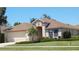 Charming single-story home featuring a well-manicured lawn, neutral color scheme, and attached two-car garage at 5255 Layton Dr, Venice, FL 34293