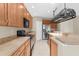 Well-lit kitchen features stainless steel appliances, ample counter space, and traditional cabinetry at 5255 Layton Dr, Venice, FL 34293