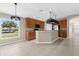 Open kitchen with stainless steel appliances, a breakfast bar, and natural light at 5255 Layton Dr, Venice, FL 34293
