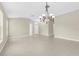 Open-concept living room featuring neutral tile floors, elegant lighting fixtures, and a bright, airy feel at 5255 Layton Dr, Venice, FL 34293